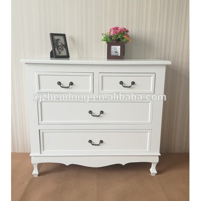 White wooden bedside table with four drawers